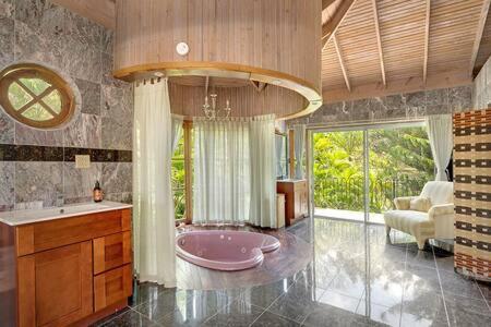 a bathroom with a pink tub in a room at Hospitality Expert Mr X Suite - Tour Pool Bar Beach in Montego Bay