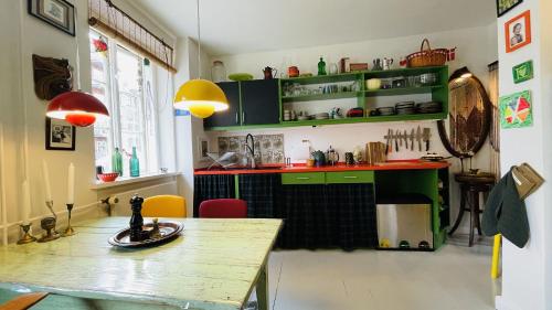 a kitchen with green cabinets and a wooden table at ApartmentInCopenhagen Apartment 1589 in Copenhagen