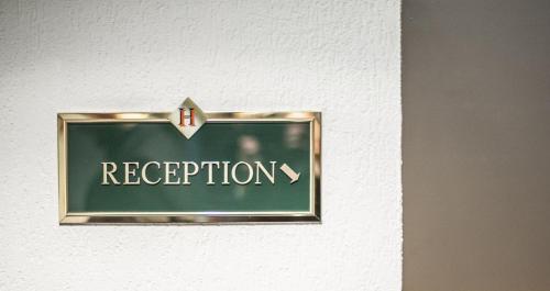 a sign on a door with the word reception at Stargaze Home Hotel in Haan