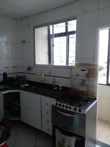 a kitchen with a stove and a sink and a window at Quarto Vila Mariana in São Paulo