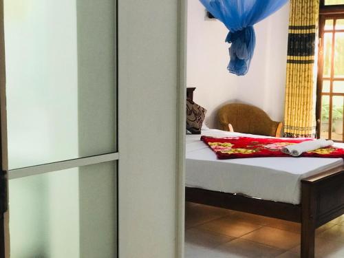 a bedroom with a bed and a window at Ella Jayamali Holiday Pavilion in Ella