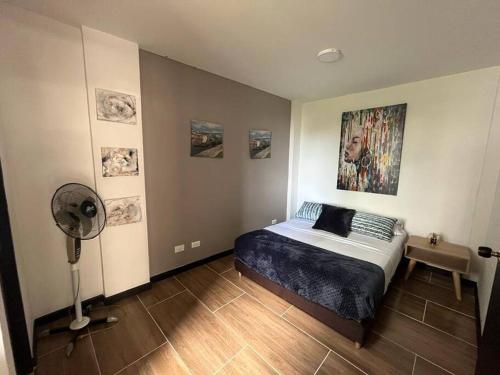 a bedroom with a bed and a fan in it at Hermoso apartamento ibagué 202 F2 in Ibagué