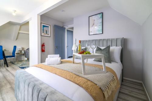 a bedroom with a bed with a table on it at 12 Elmwood in Harrow