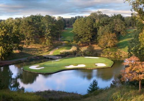 an aerial view of a golf course with a pond at Griffin Hotel, an official Colonial Williamsburg Hotel in Williamsburg