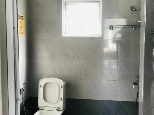 a bathroom with a toilet and a window at Ella Jayamali Holiday Pavilion in Ella