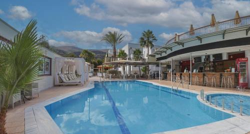 a large swimming pool in front of a hotel at Bella Elena by Estia in Malia