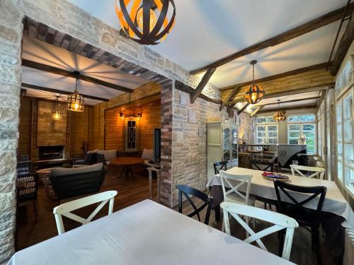 a dining room with white tables and chairs at Villa Adis with Hot Pool & Jacuzzi by BookVillaBG in Borovets
