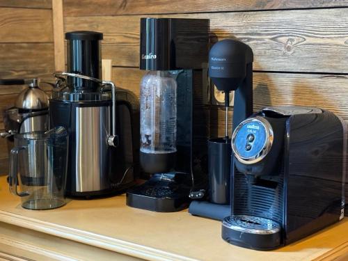 a counter with a coffee maker and other appliances at Villa Adis with Hot Pool & Jacuzzi by BookVillaBG in Borovets