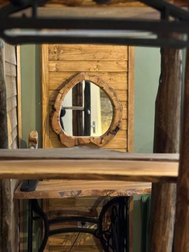 a mirror on top of a wooden table at Villa Adis with Hot Pool & Jacuzzi by BookVillaBG in Borovets