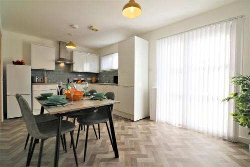 a kitchen and dining room with a table and chairs at Signature - Great Western View in Whiteinch