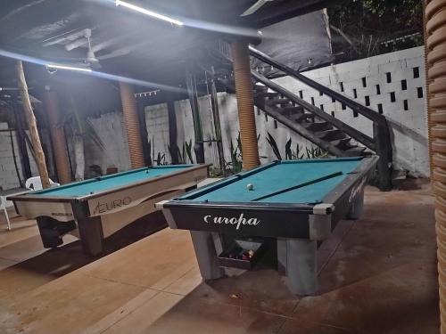 two pool tables in a room with a staircase at Eco hotel summer beach in Cartagena de Indias
