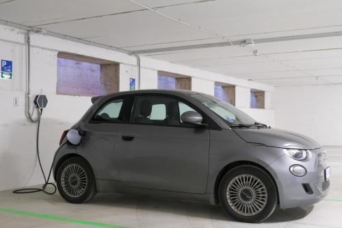 a small car is plugged into a charger at Emerald Green Residence in Caldiero