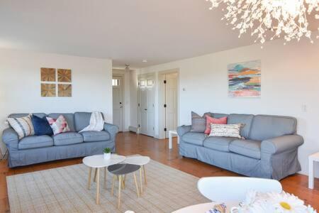 a living room with a couch and a table at Beautiful Water Views Dogs Welcome in Truro