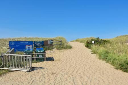 a sandy path on a beach with a shopping cart at Beautiful Water Views Dogs Welcome in Truro