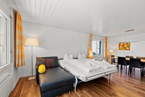 a bedroom with a bed and a dining room at Seestrasse 3, Whg 104 in Lenzerheide