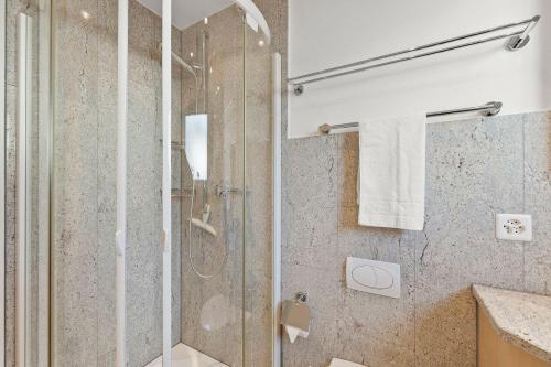 a bathroom with a shower with a glass door at Seestrasse 3, Whg 104 in Lenzerheide