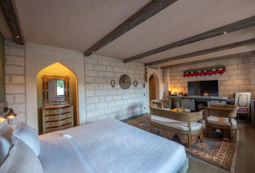 a bedroom with a large bed and a kitchen at AJWA Cappadocia in Ürgüp