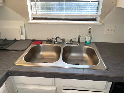 a stainless steel sink in a kitchen with a window at Tendayis Paradise - Work Crew Lodging in Abilene