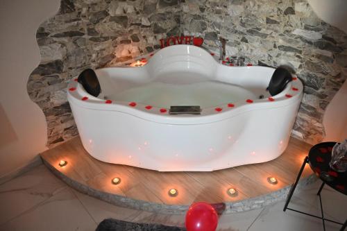a bath tub in a room with a stone wall at Vesuvius Dream in Boscotrecase