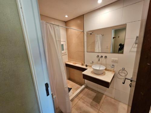 a bathroom with a sink and a mirror at Cabañas Bosque y Mar in Mar de Cobo