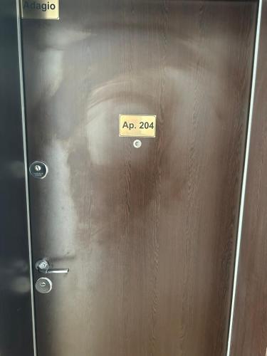 a metal door with a sign that reads at Adagio apartment in Creţuleasca