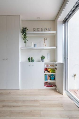 a kitchen with white cabinets and an open refrigerator at Mifi Beach Luxury Duplex by MP in Vila Nova de Gaia