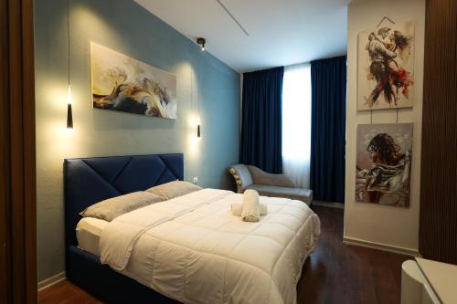 a bedroom with a king sized bed in a room at Grandstay Apartments in Durrës