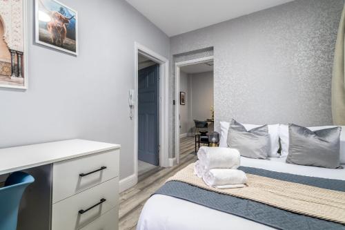 a small bedroom with a bed and a desk at 12 Elmwood in Harrow