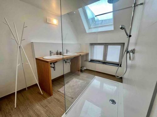a bathroom with a sink and a glass shower at Le contemporain - Plein centre, place du Marché in Liège
