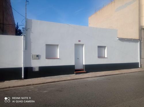 a white building on the side of a street at Casa La via in Camarles