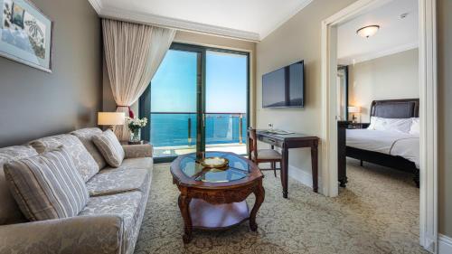 a living room with a couch and a bed and a table at Royal Princess Hotel in Dubrovnik