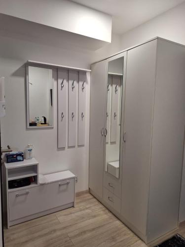 a bathroom with white cabinets and a sink at Comfort Stay, EV, Parking in Bolesławiec