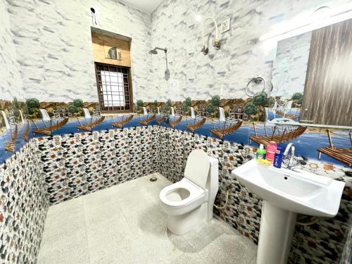 a bathroom with a white toilet and a sink at Very spacious terrace with rooms for holi party in Gurgaon