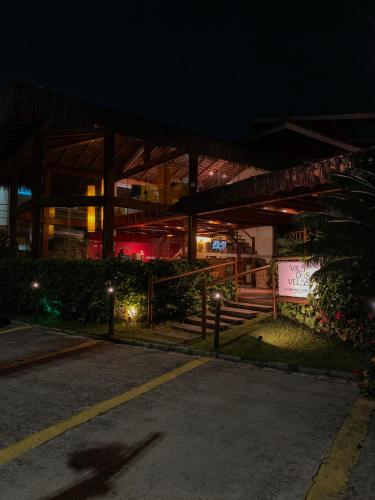 a building at night with lights in front of it at Pousada Vila das Velas in Ilhabela