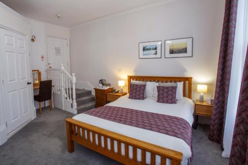 a hotel room with a bed and a staircase at The Buttery in Oxford