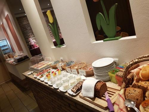 a buffet with bread and other foods on a table at Hotel Landgasthof Hirsch in Marktlustenau