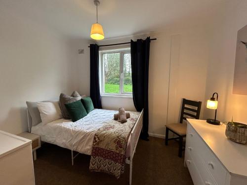 a small bedroom with a bed and a window at Entire 4-bed, near town centre in Falmouth