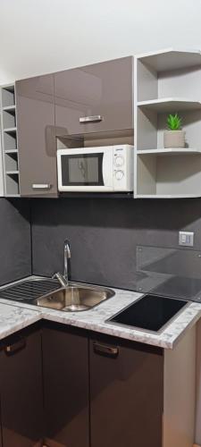 a kitchen with a sink and a microwave at Studio Apartment Nani Centar in Split