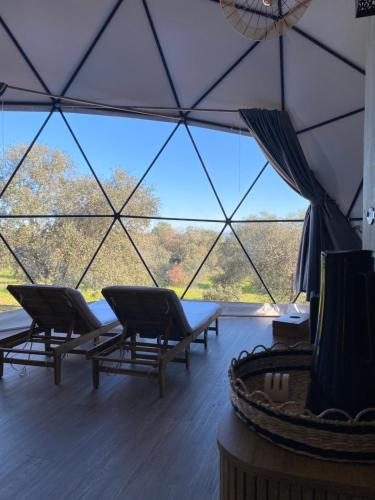 a room with chairs and a large glass ceiling at Montimerso Skyscape Countryhouse in Monsaraz