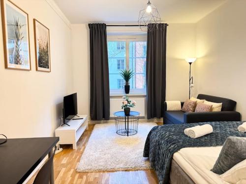 a living room with a bed and a couch at Stay Inn Söder Cozy apartment in Stockholm