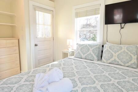 a bedroom with a large bed and a window at 4 Min Drive to Bayside Beaches in Eastham