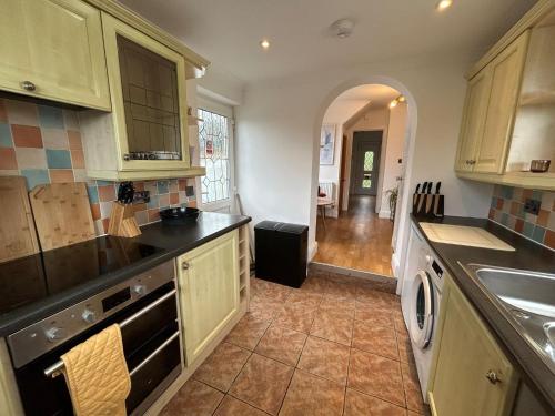 a kitchen with a sink and a stove at Entire 4-bed, near town centre in Falmouth