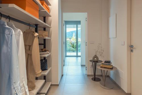 a room with a hallway with a closet and a table at Grand Hotel Majestic in Verbania