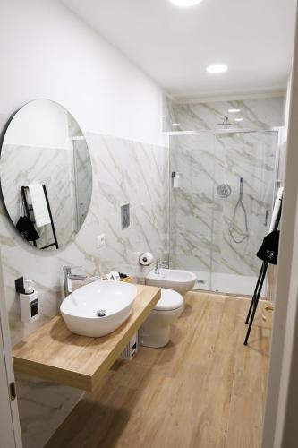 a bathroom with a sink and a toilet and a mirror at Toledo 292 Luxury House in Naples