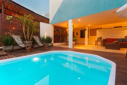 a swimming pool in front of a house at Valencia Hotel Natal in Natal