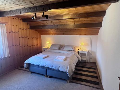 SchmittenにあるFerienhaus Vardaval - Schmitten / GRの木製の壁のベッドルーム1室(ベッド1台付)
