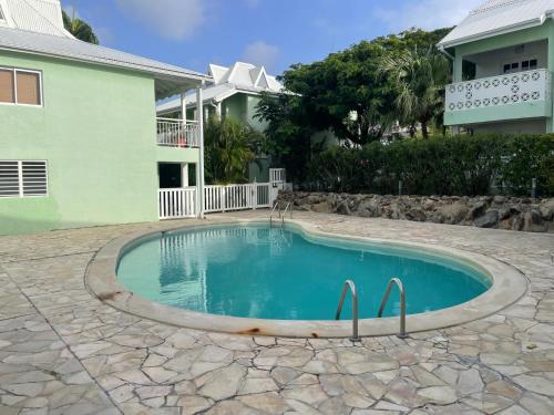 a swimming pool in front of a house at Studio Cocooning in Saint Martin
