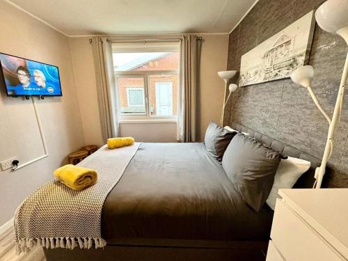 a bedroom with a large bed with a window at 247a South Shore Pet friendly in Bridlington