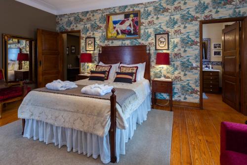 a bedroom with a bed with towels on it at Charming Antas House in Porto