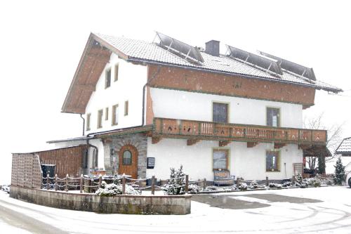 a large house with snow on the roof at Appartement Natalie in Ried im Zillertal